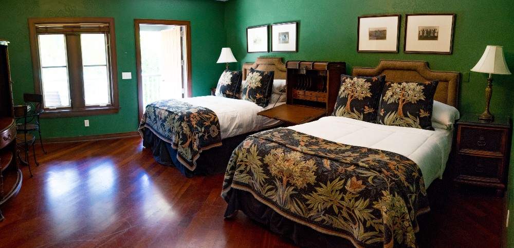 Room with green walls and two queen sized beds