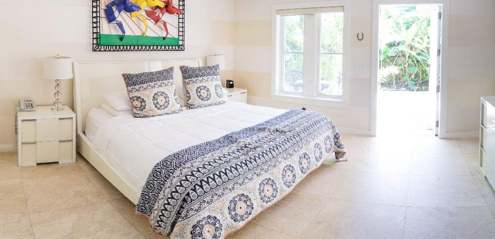 White airy room with blue mosaic duvet
