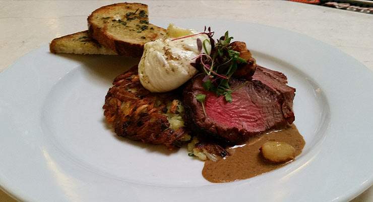 Steak and gravy with sliced potatoes