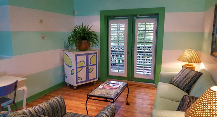 Pink and green striped walls with green trimmed double doors
