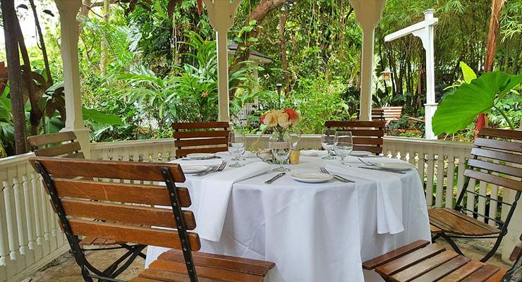 Table setting with white table cloth under gazeebo