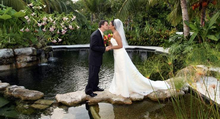 Husband and Wife kissing on a pond